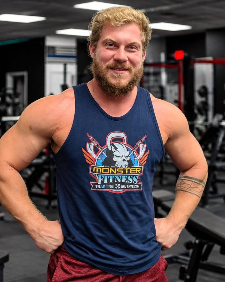 Dakoda Smith, personal trainer, in a Monster Fitness tank top standing in a gym